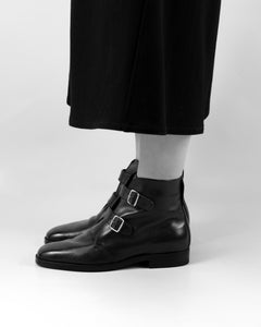 Side view of elegant women’s double-buckle boot with sleek silhouette and Blake construction