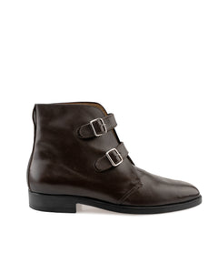 Side view of elegant women’s double-buckle boot with sleek silhouette and Blake construction
